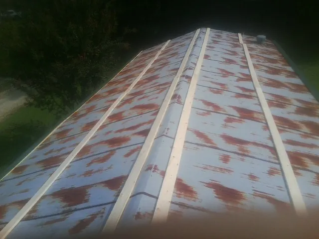 Rusted metal roof panels with new wood purlins before replacement — Storm Damage Roof Repair in Hermanville by Roofing Brothers