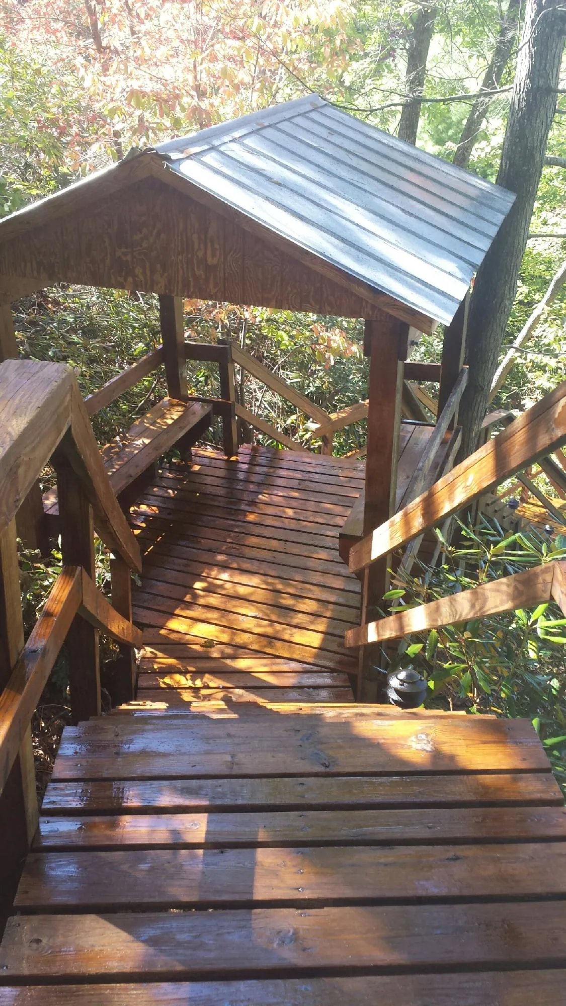 Freshly stained wood walkway and covered shelter with a metal roof in Hermanville